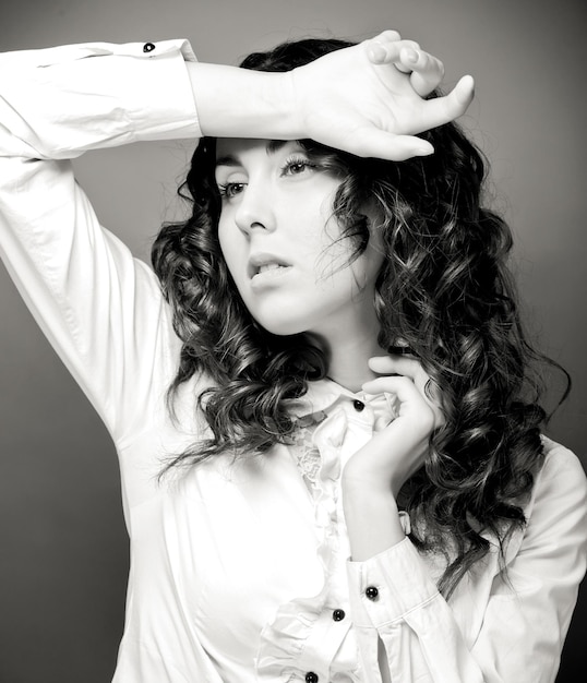 Portrait of pretty young woman with curly hair