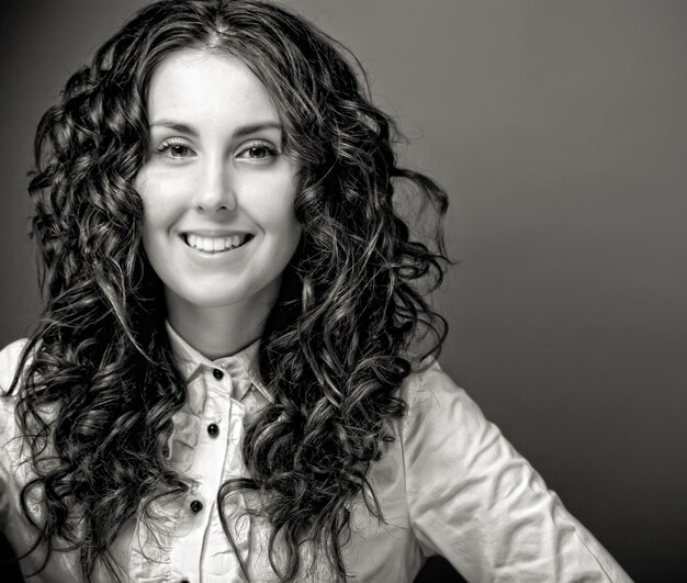 Portrait of pretty young woman with curly hair