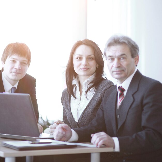 Portrait of a professional business team sitting behind a Desk