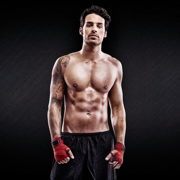 Portrait of pure fighting prowess Studio shot of a confident young boxer isolated on black