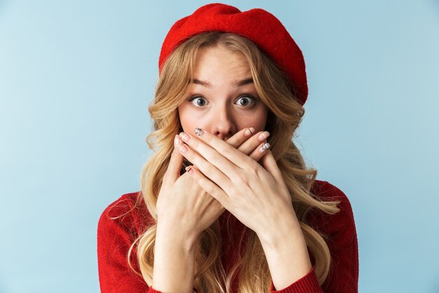 Portrait of quiet blond woman 20s wearing red beret c