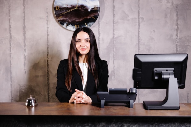 Portrait of receptionist at desk in lobby Banner design Friendly concierge at hotel reception behind the counter