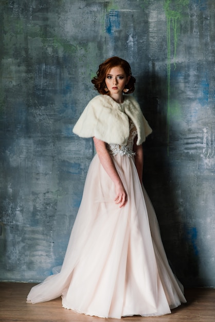 Portrait of red haired girl wearing wedding dress