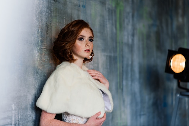 Portrait of red haired girl wearing wedding dress