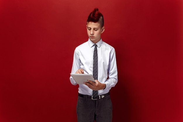 Portrait of red-haired teen punk with tablet