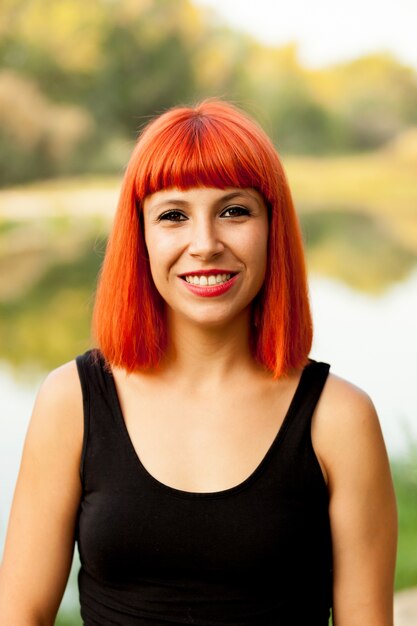 Portrait of red haired woman enjoying of the nature