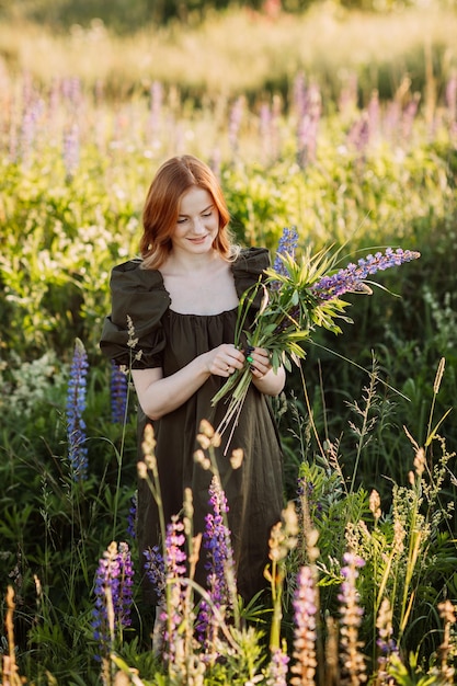 Portrait of a redhaired girl in a thicket of lupin 3274