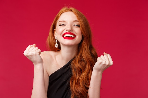 Portrait of a redhead woman in stylish black dress