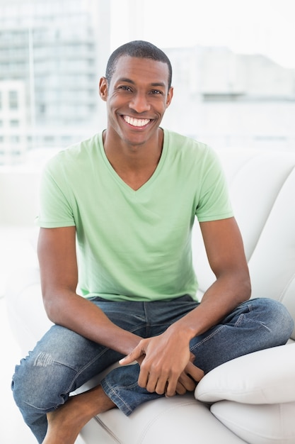 Портрет расслабленной афро человека, сидя на диване