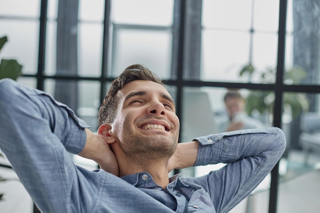 Portrait of relaxed businessman in modern office