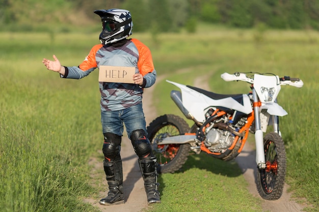 Portrait of rider holding help sign in the forrest