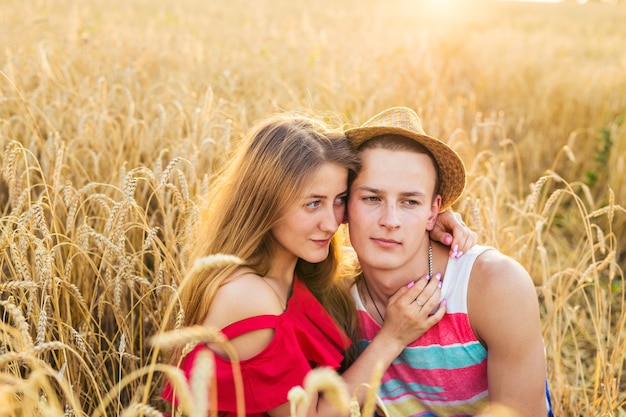 Portrait of romantic couple embraces in the field