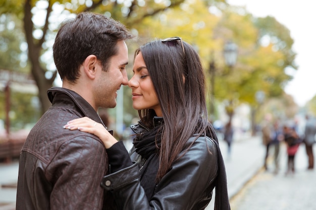 Portrait of romantic couple hugging outdoors