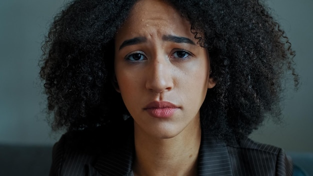 Portrait sad female african american girl student serious anxious looking at camera frustrated