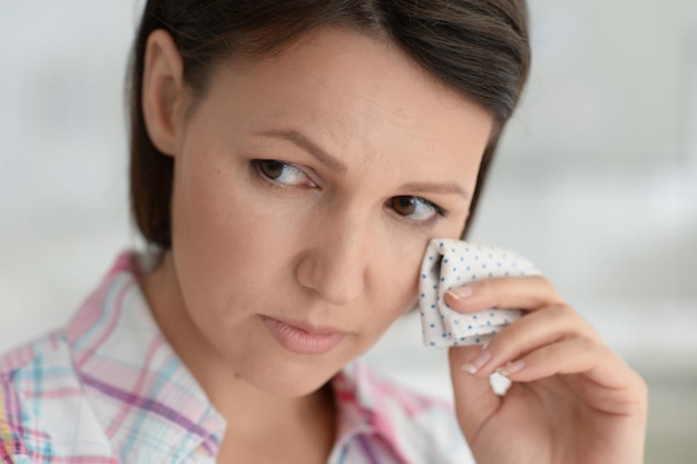 Portrait of sad ill young woman at home