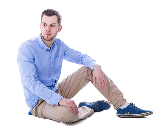 Portrait of sad man thinking about something sitting isolated on white background