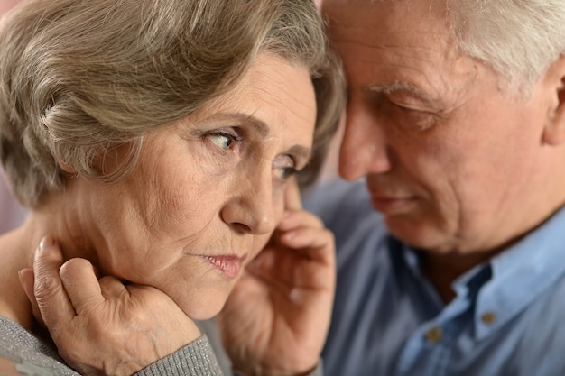 Portrait of a sad senior couple at home