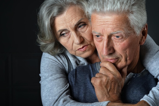 Portrait of sad senior couple posing at home