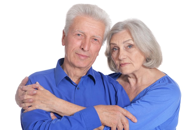 Portrait of sad senior couple on white background