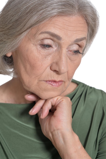 Portrait of sad senior woman isolated on white background