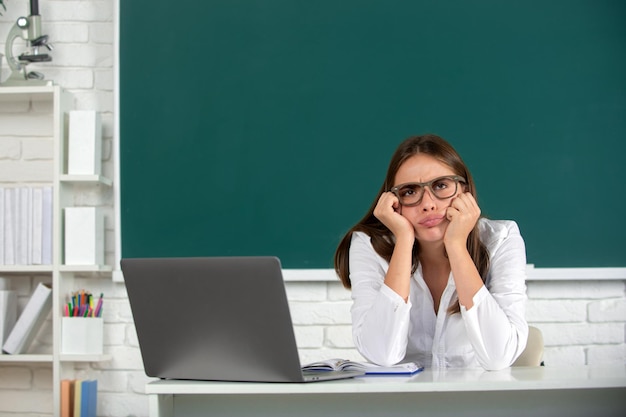 Portrait of sad serious and angry female university student study lesson at school or university