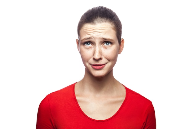 Photo portrait of sad unhappy woman in red tshirt with freckles