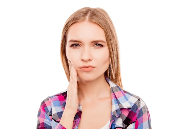 Portrait of sad woman having toothache and touching cheek