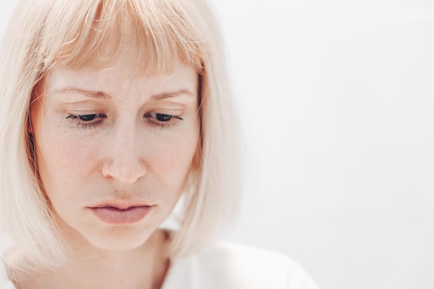 Portrait of a sad woman on a white background