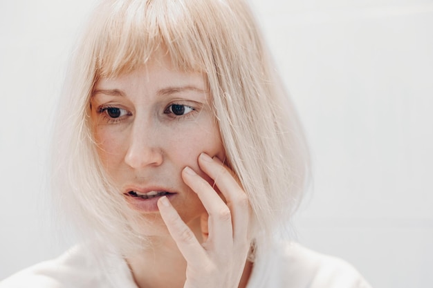 Portrait of a sad woman on a white background