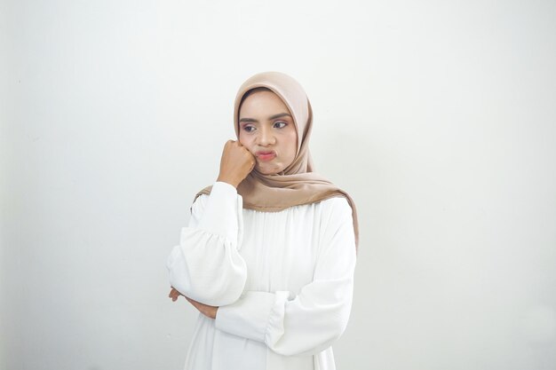 Portrait of sad young Asian muslim woman isolated white background