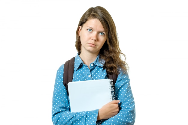 Portrait of sad young student girl with books