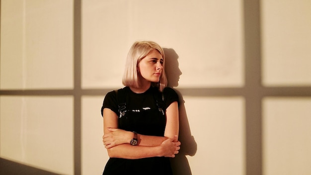 Portrait of sad young woman leaning on wall