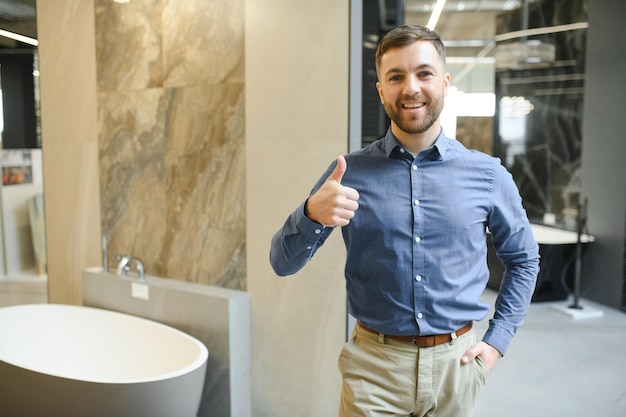 Photo portrait of salesperson in bathroom store happy man works in bath store sales occupation