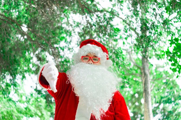 Portrait of santa claus on bokeh light under treeThailand peopleSent happiness for childrenMerry christmasWelcome to winter