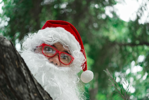 Portrait of santa claus on bokeh light under treeThailand peopleSent happiness for childrenMerry christmasWelcome to winter