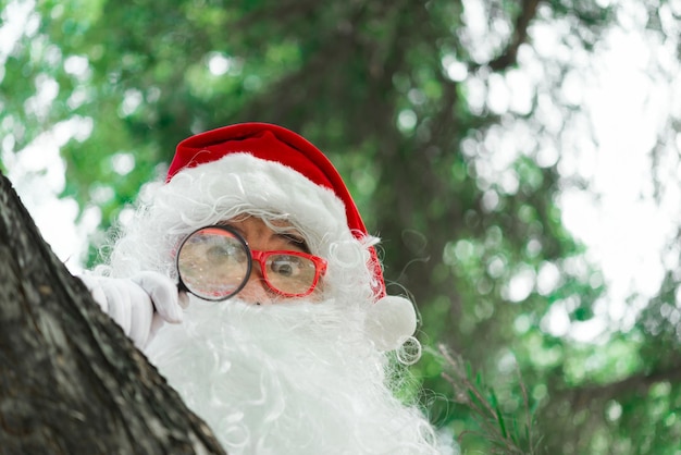 Portrait of santa claus on bokeh light under treeThailand peopleSent happiness for childrenMerry christmasWelcome to winter