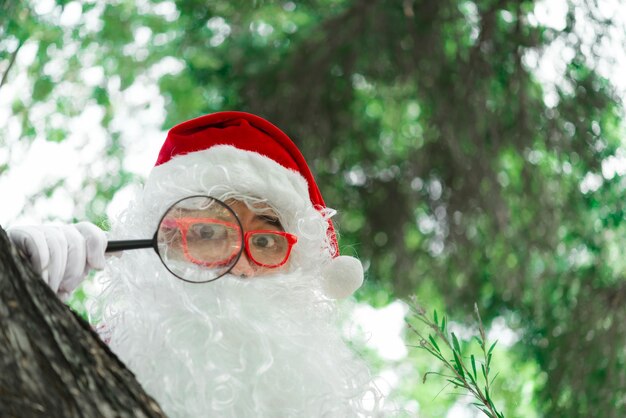 Portrait of santa claus on bokeh light under treeThailand peopleSent happiness for childrenMerry christmasWelcome to winter