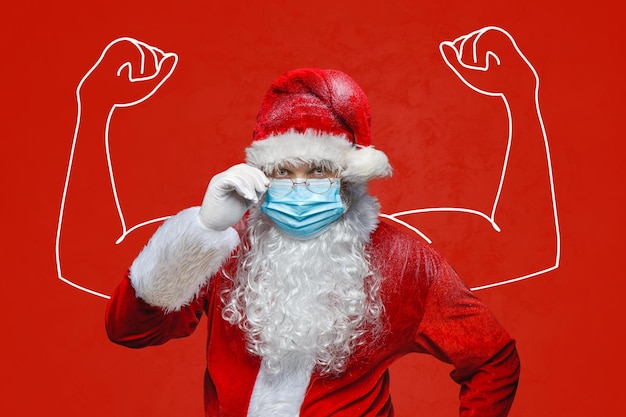 Portrait of a Santa Claus in a breathing mask on the red background shows muscle