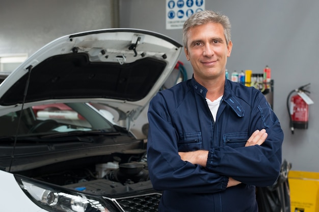 Portrait Of Satisfied Auto Mechanic With Arm Crossed