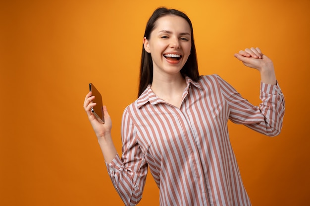 Portrait of a satisfied casual girl celebrating success