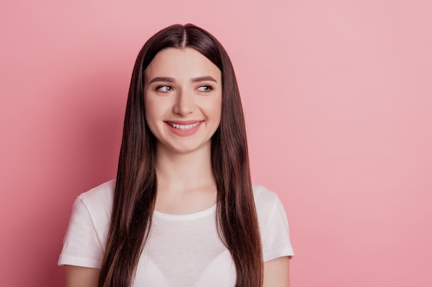 Portrait of satisfied girl happy positive smile look empty space isolated over shine color background