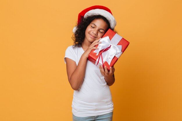 Portrait of a satisfied little african girl dressed in christmas hat