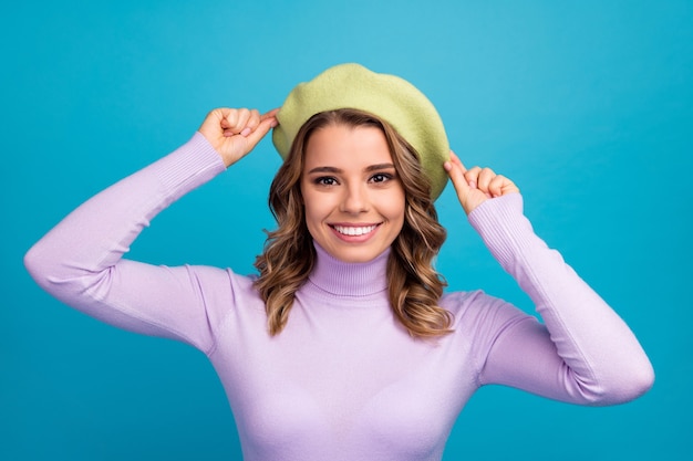 Portrait of satisfied lovely attractive girl on blue wall