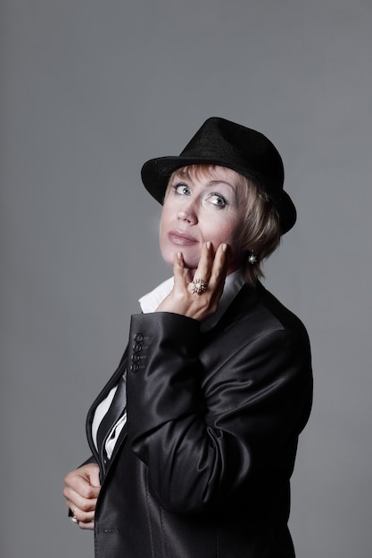 Portrait of a scandalous woman in a black hat .isolated on gray background.