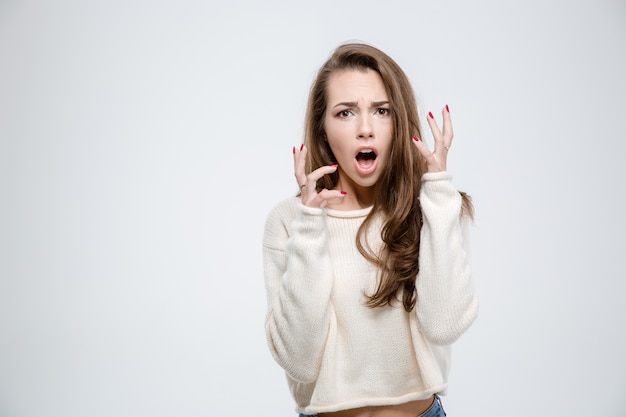 Portrait of a scared woman looking at camera isolated on a white background