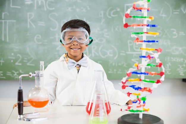 Portrait of schoolboy doing a chemical experiment in laboratory