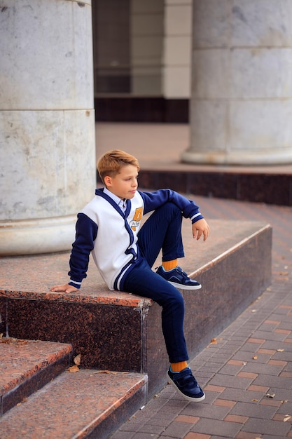 Portrait of a schoolboy teenager 12 years old in stylish school clothes back to school