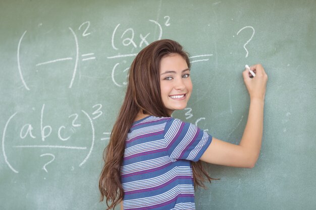 Portrait of schoolgirl pretending to be a teacher in classroom