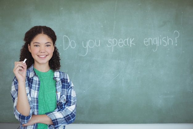 Portrait of schoolgirl pretending to be a teacher in classroom