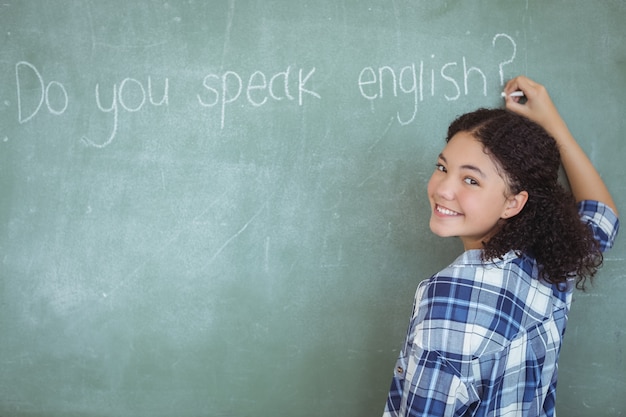 Portrait of schoolgirl pretending to be a teacher in classroom